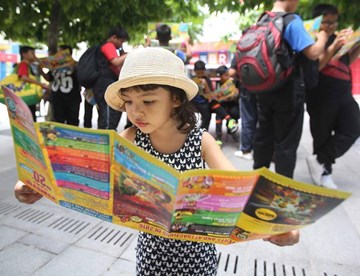 Girl reading Park Brochure