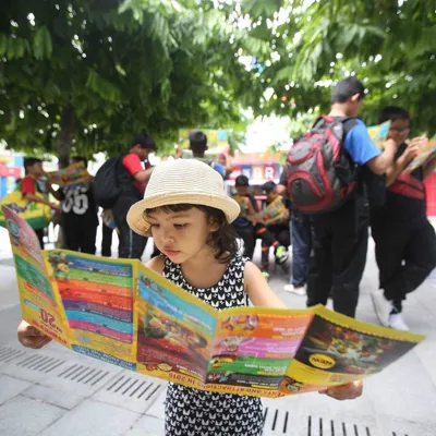 Girl reading Park Brochure